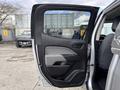 2018 Chevrolet Colorado with an open front door showing the interior design and seating configuration