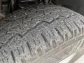Close-up of a worn tire on a 2011 Ford F-350 SD showcasing tread patterns and dirt accumulation