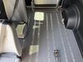 Interior of a 2021 RAM Promaster showing the floor with metal strips and a seat back resting against the side wall