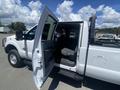 A 2016 Ford F-350 SD with an open passenger door showcasing the interior and seating area