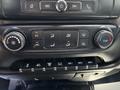 The dashboard controls of a 2020 Chevrolet Silverado featuring climate controls and multiple buttons for auxiliary functions