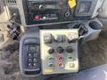 A control panel featuring various switches and buttons for a 2014 International 7400 truck including levers for controls and a digital display