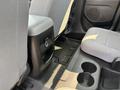 Interior of a 2017 Chevrolet Colorado showing the rear seating area with fabric seats a center console and cup holders