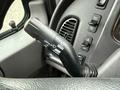 Close-up of a turn signal lever in a 2016 Freightliner 108SD featuring various control buttons and indicators on the dashboard