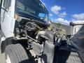A 1997 Freightliner FL70 truck showing the open engine compartment with various engine components visible including the exhaust and pipes