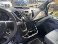 2016 Ford Transit 150 interior showcasing the dashboard gear shift cup holders and control buttons