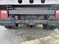 A 2013 RAM 5500 truck's rear undercarriage showing the hitch receiver and electrical connections with two red taillights on either side