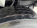 Close-up of a worn tire on a 2011 International 7500 showing visible tread wear and cracks in the rubber surface