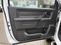 Interior door panel of a 2012 Dodge Ram 5500 with a black plastic finish and a handle for opening the door