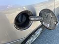 Close-up of the fuel cap opening on a silver 2006 Pontiac G6 showing the fuel filler neck with the cap removed
