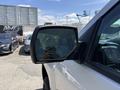 A 2016 Chevrolet Silverado 2500HD with a side mirror reflecting the surrounding area
