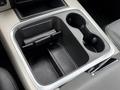 A center console with cup holders and storage space in a 2018 RAM 1500