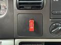 A red switch labeled "ON SPOT CHAINS" on the dashboard of a 2007 Ford F-550