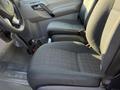 Interior view of a 2016 Mercedes-Benz Sprinter featuring two black fabric seats and a steering wheel with control buttons