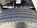 Close-up of a worn tire from a 2011 International 4300 showing visible tread patterns and signs of use