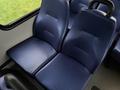 Two blue upholstered seats in a vehicle interior with a textured surface and armrests
