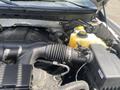 Close-up of the engine compartment of a 2014 Ford F-150 showing the engine cover intake and coolant reservoir