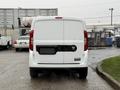 A white 2017 RAM ProMaster City viewed from the rear with a simplistic design and the RAM logo on the back door