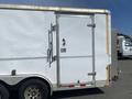 A white 2008 Wells Industries Inc EW1422 trailer with a metallic side door featuring a handle and lock on the left side