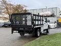 A 2019 Ford F-350 SD truck with a flatbed and a black metal fence structure in the back is parked with its rear facing the viewer