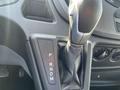 Close-up of the gear shift of a 2017 Ford Transit with markings for park reverse neutral drive and manual