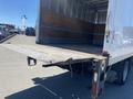 2015 Ford F-450 SD with a lowered loading ramp at the back of a truck body