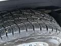 Close-up of a heavily treaded tire from a 2016 GMC Savana showing deep grooves and rugged design for traction