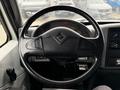 Steering wheel of a 2006 International 4200 with controls on the left side and dashboard elements visible on the right side