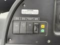 Control panel of a 2018 Grande West Vicinity featuring buttons for driver heater mirror de-icer windshield de-icer and dimmer switch