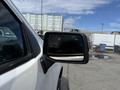 A side mirror of a 2019 Chevrolet Silverado 1500 reflecting a cloudy sky
