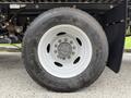 A close-up view of a white wheel of a 2022 Ford F600 showing the tire tread and silver hubcap