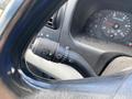 Close-up of the steering column controls of a 2007 Ford F-350 SD showing the turn signal and windshield wiper controls