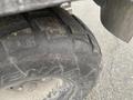 Close-up of a worn tire from a 2010 Kubota RTV 900 showing the tread pattern and sidewall markings