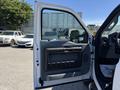 A 2014 Ford F-250 SD with its driver's side door open showing the interior door panel and handle