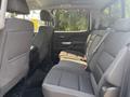 Interior view of the back seat of a 2017 Chevrolet Silverado 1500 with gray fabric upholstery and a spacious seating arrangement