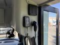 A control panel with two buttons and a microphone attached to the interior of a 2020 Chevrolet Express van
