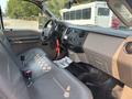 Interior of a 2009 Ford F-450 Super Duty showing the driver's seat dashboard and controls with gray upholstery and a floor mat