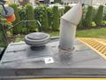 The image shows the top of a 2012 Caterpillar 980 featuring a circular air cleaner and a tall exhaust stack