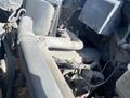 Engine compartment of a 1996 GMC Top Kick showing various visible components including pipes wires and an electronic control module