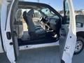 A 2016 Ford F-250 SD with one front door open showing the interior featuring gray seats and a dashboard without visible occupants