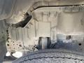 The underside of a 2019 Hino 195 showing a portion of the chassis and suspension components with visible dirt and wear on the surfaces