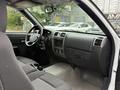 Interior of a 2012 GMC Canyon showing the steering wheel dashboard and front seats in gray upholstery