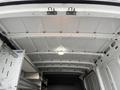The interior of a 2017 Mercedes-Benz Sprinter van showing a white ceiling with metal supports and a light fixture