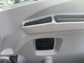 Interior door panel of a 2020 Lion Lion6 featuring a control switch and a small storage compartment