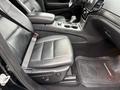 Black leather interior of a 2019 Jeep Grand Cherokee featuring a bucket seat center console and gear shifter