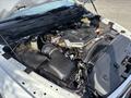 The image shows the engine compartment of a 2013 RAM 5500 with various components including the engine block air intake and fluid reservoirs