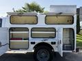 2015 Ford F-550 service truck with open storage compartments and toolboxes on the side
