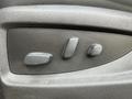 A close-up of the seat adjustment controls on the door panel of a 2017 Chevrolet Silverado 1500 featuring three buttons in a textured black surface