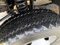 Close-up of a rugged tire with deep treads mounted on a wheel from a 2010 Ford F-550