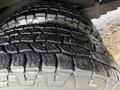 Close-up of two worn tires showing detailed tread patterns on a 2013 Chevrolet Express